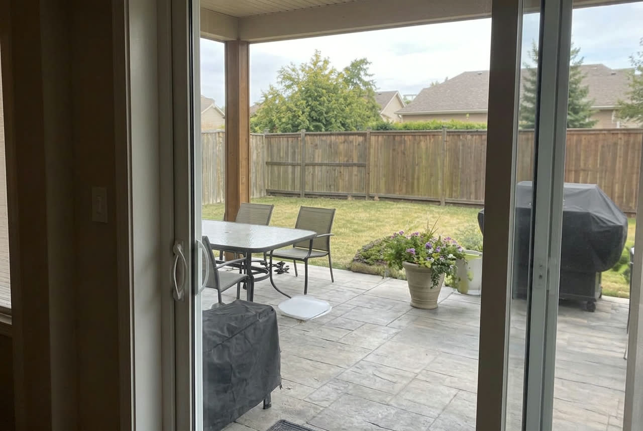 The same patio door with clear new tempered glass after replacement
